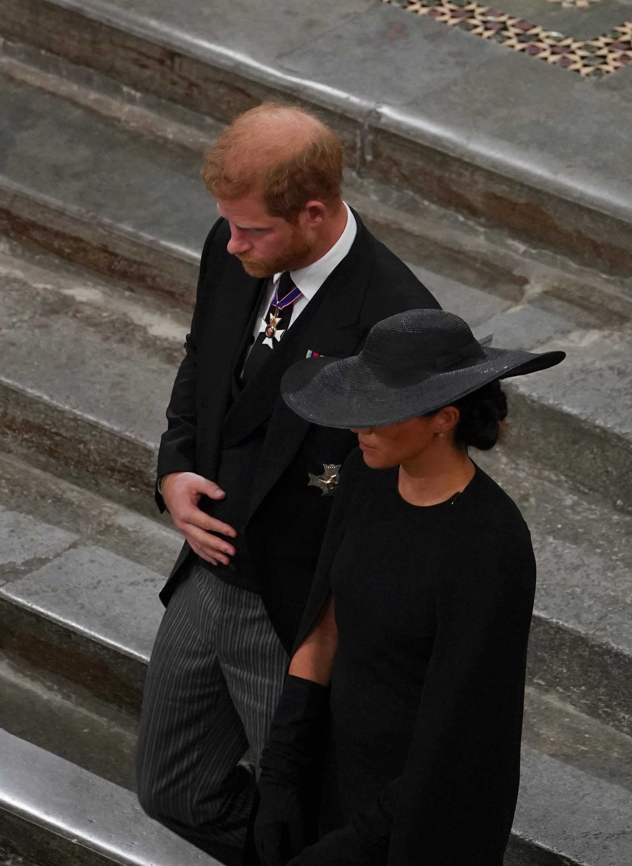 Prince Harry and Meghan Markle follow the bearer party with Queen Elizabeth II's coffin as it leaves Westminster Abbey towards Wellington Arch on September 19, 2022 in London, England |  Source: Getty Images