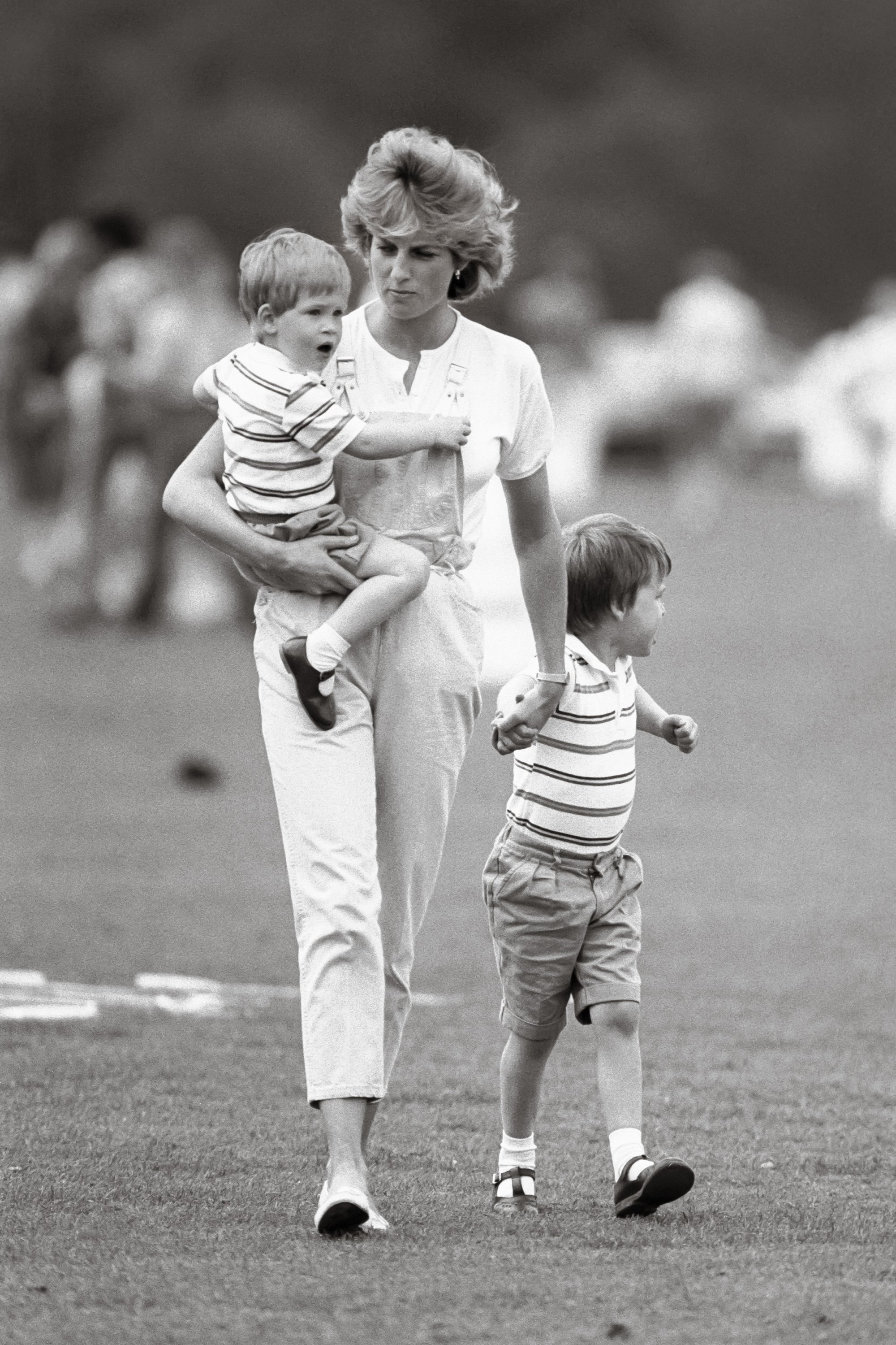 Diana, Princess of Wales, Prince William and Prince Harry at a polo match at Smiths Lawn, Windsor in 1987 |  Source: Getty Images